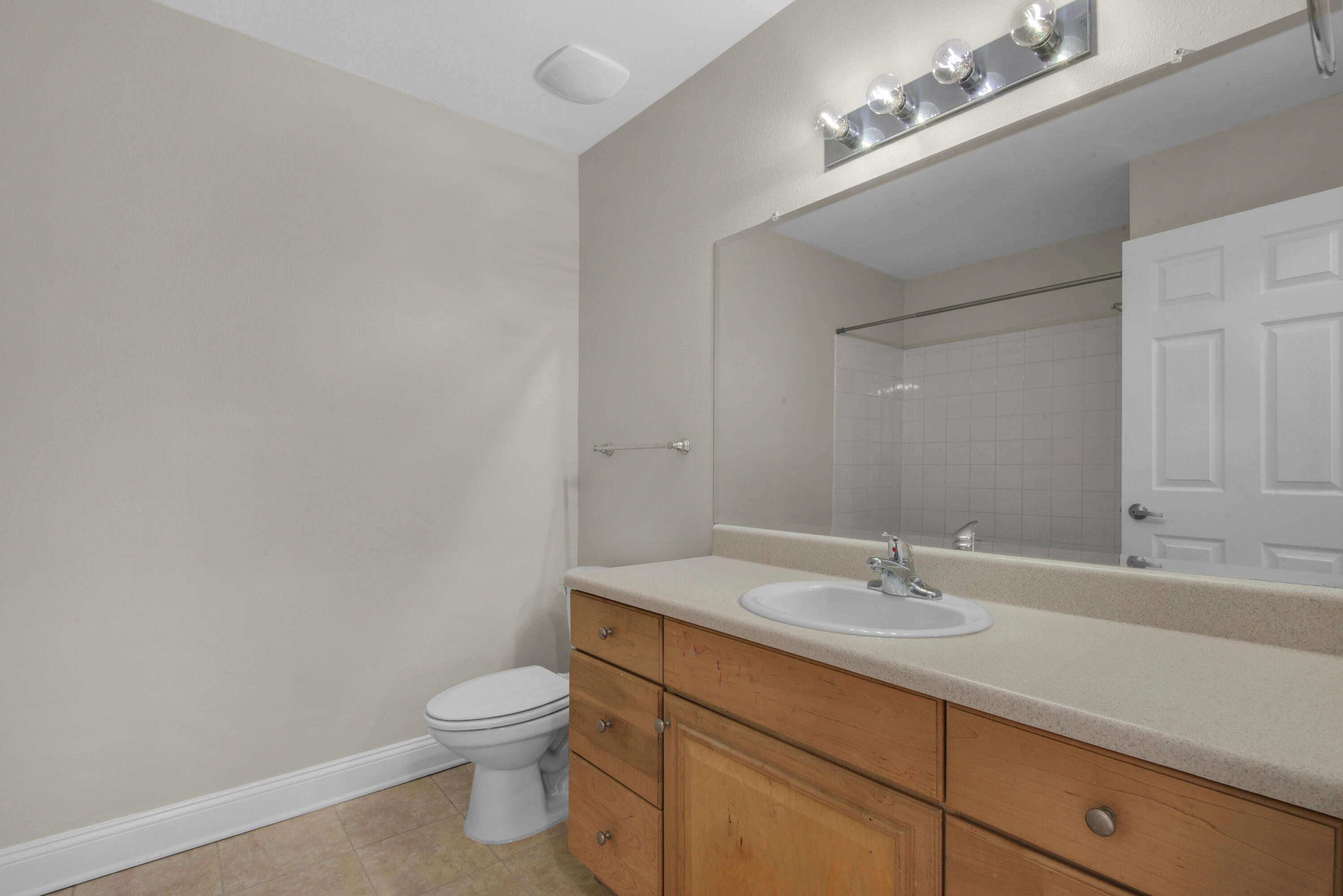 537 Wingspan Way Crestview, FL 32536 - Photo 23 of 34 a bathroom with a granite countertop toilet a sink and a mirror