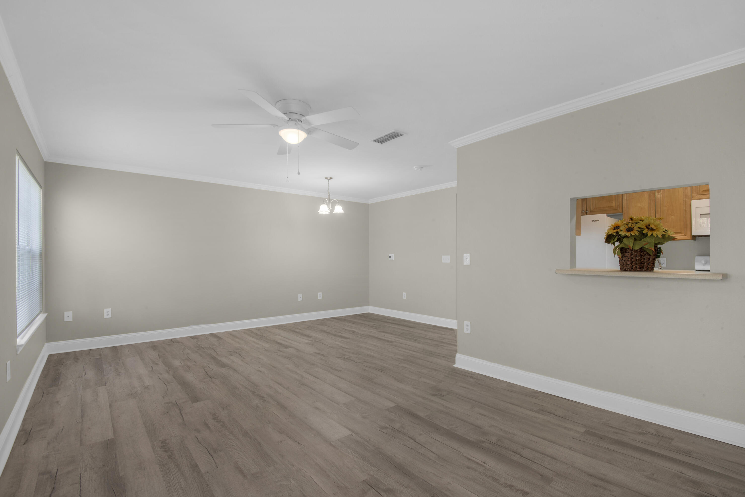 537 Wingspan Way Crestview, FL 32536 - Photo 5 of 34 a view of an empty room with wooden floor and a window