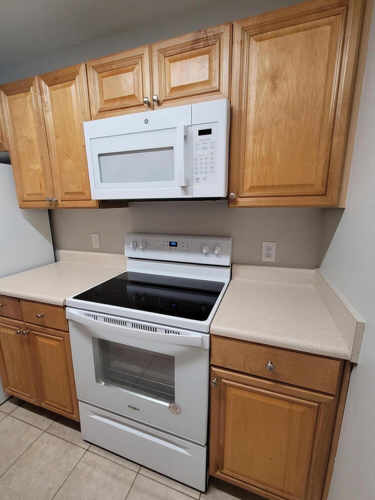 537 Wingspan Way Crestview, FL 32536 - Photo 10 of 34 a kitchen with granite countertop white cabinets and white appliances