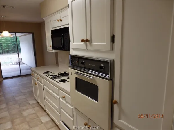 a kitchen with stainless steel appliances granite countertop a stove and a microwave