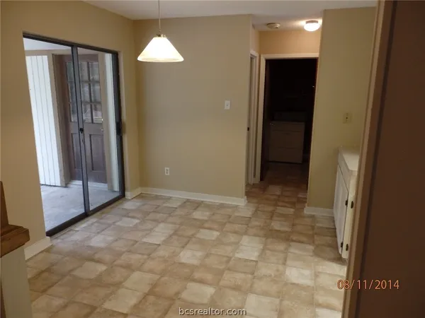 an empty room with closet and a bathroom