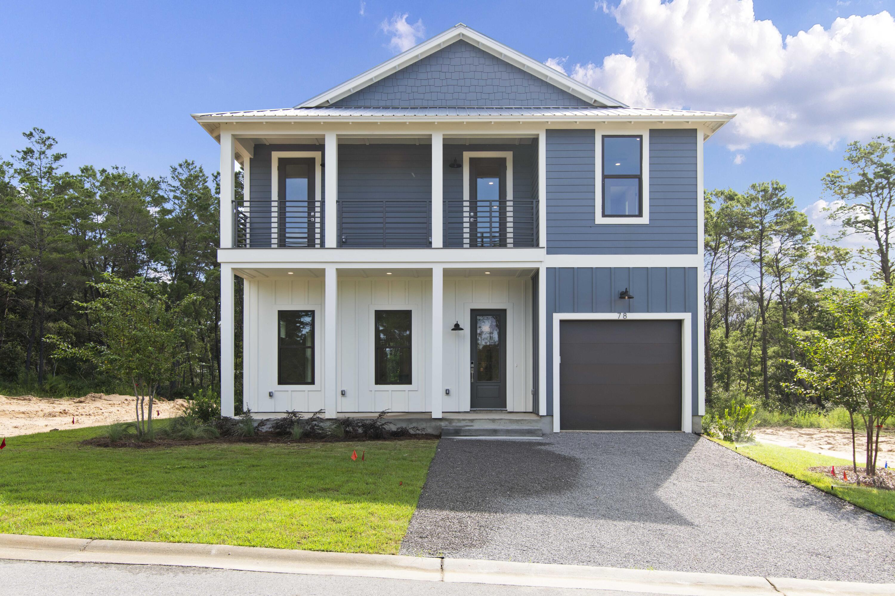 a front view of a house with a garden and yard