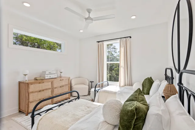 a bedroom with furniture and a large window