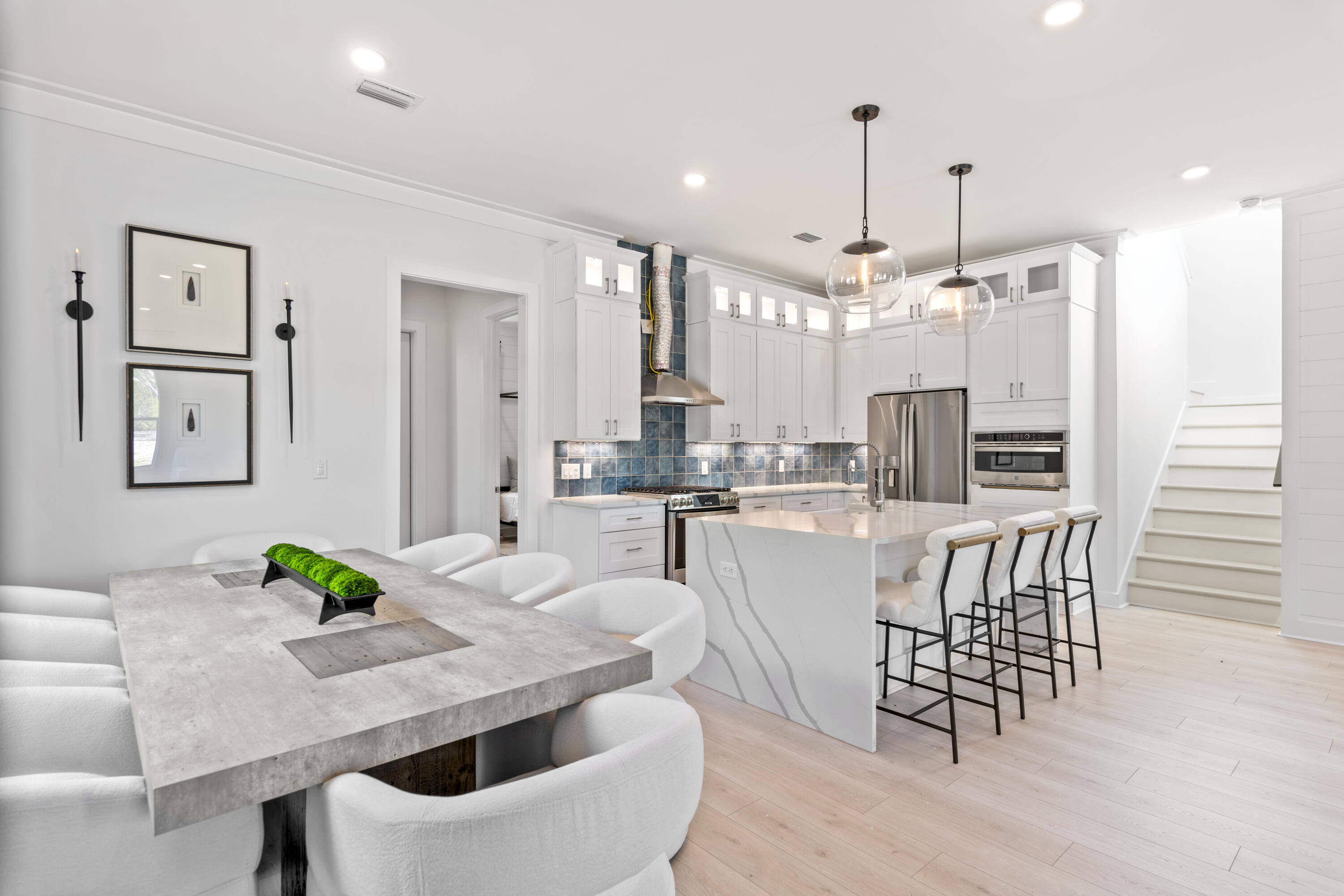 58 Sarah St Inlet Beach, Unit LOT 25 Inlet Beach, FL 32461 - Photo 5 of 31 a dining room with furniture a large window and stainless steel appliances
