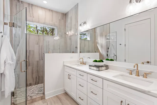 a bathroom with a double vanity sink and a mirror