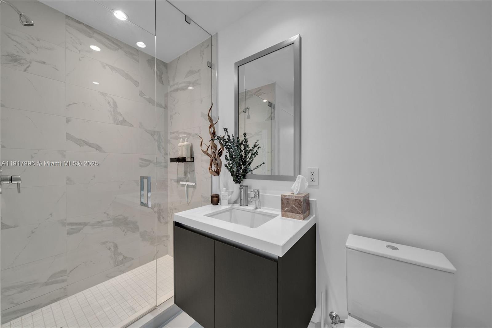 851 Northeast 1st Avenue, Unit 2203 Miami, FL 33132 - Photo 11 of 53 a bathroom with a sink a toilet and shower