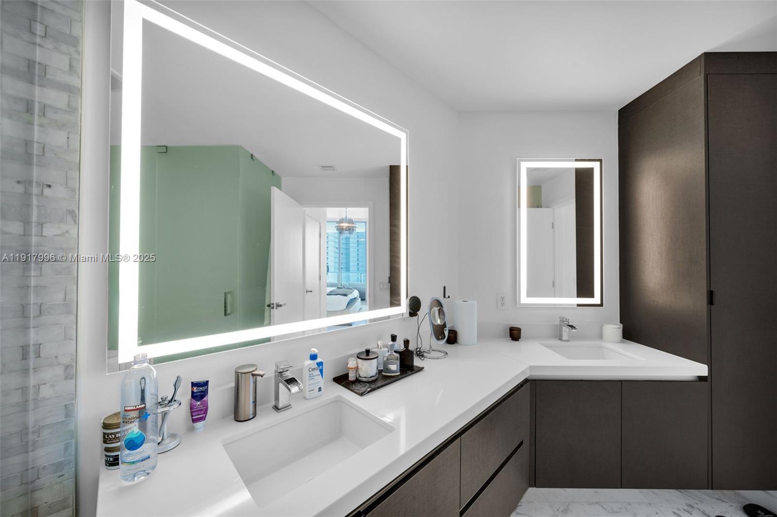 851 Northeast 1st Avenue, Unit 2203 Miami, FL 33132 - Photo 22 of 53 a bathroom with a sink and a mirror