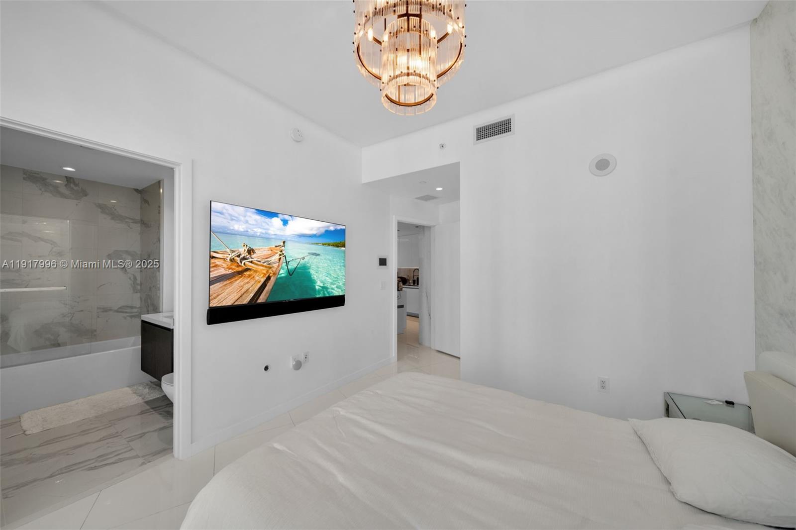 851 Northeast 1st Avenue, Unit 2203 Miami, FL 33132 - Photo 25 of 53 a bedroom with a bed and a flat screen tv