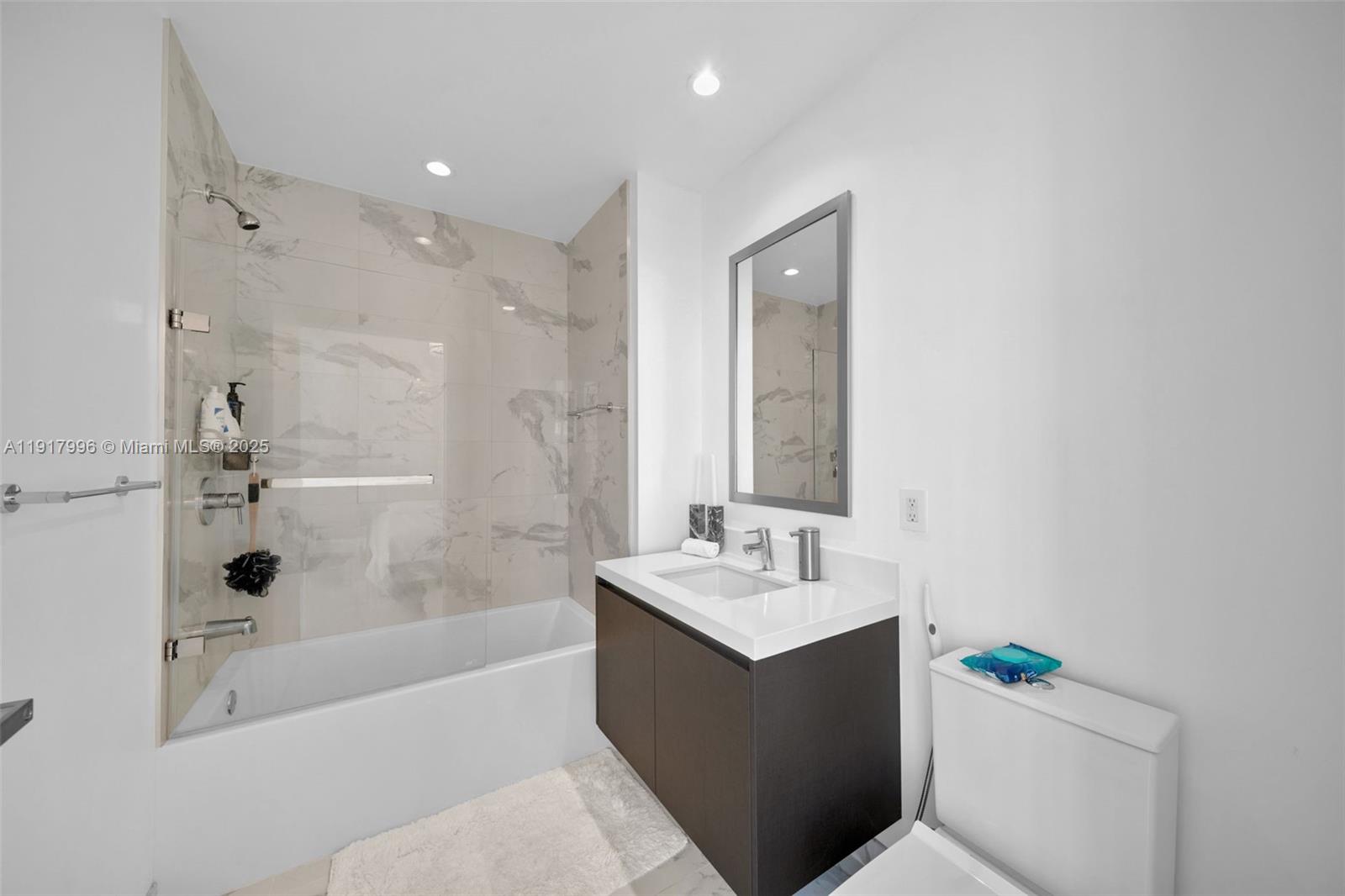 851 Northeast 1st Avenue, Unit 2203 Miami, FL 33132 - Photo 26 of 53 a bathroom with a sink a toilet and shower