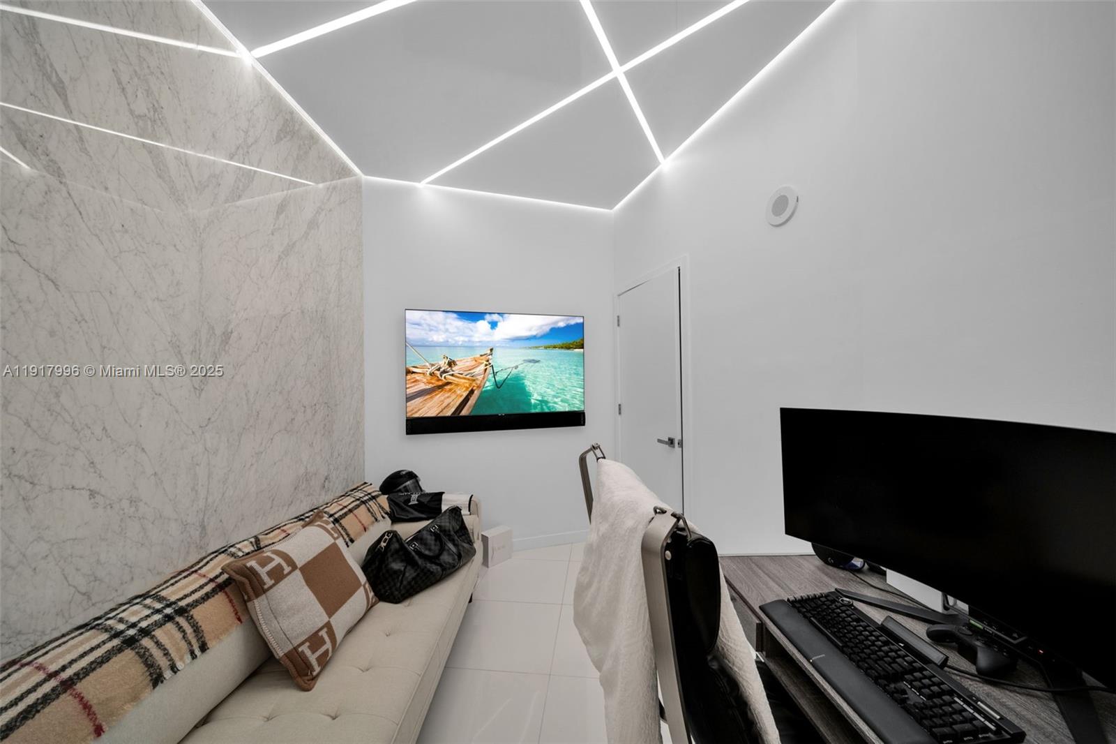 851 Northeast 1st Avenue, Unit 2203 Miami, FL 33132 - Photo 27 of 53 a room with furniture and a flat screen tv