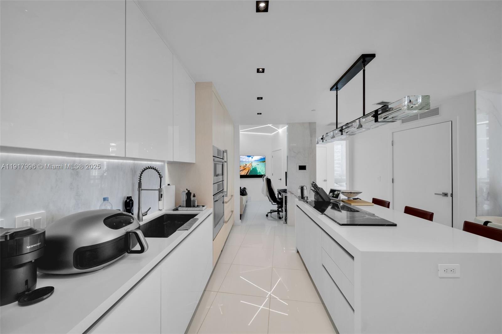 851 Northeast 1st Avenue, Unit 2203 Miami, FL 33132 - Photo 29 of 53 a view of a kitchen with a sink and living room