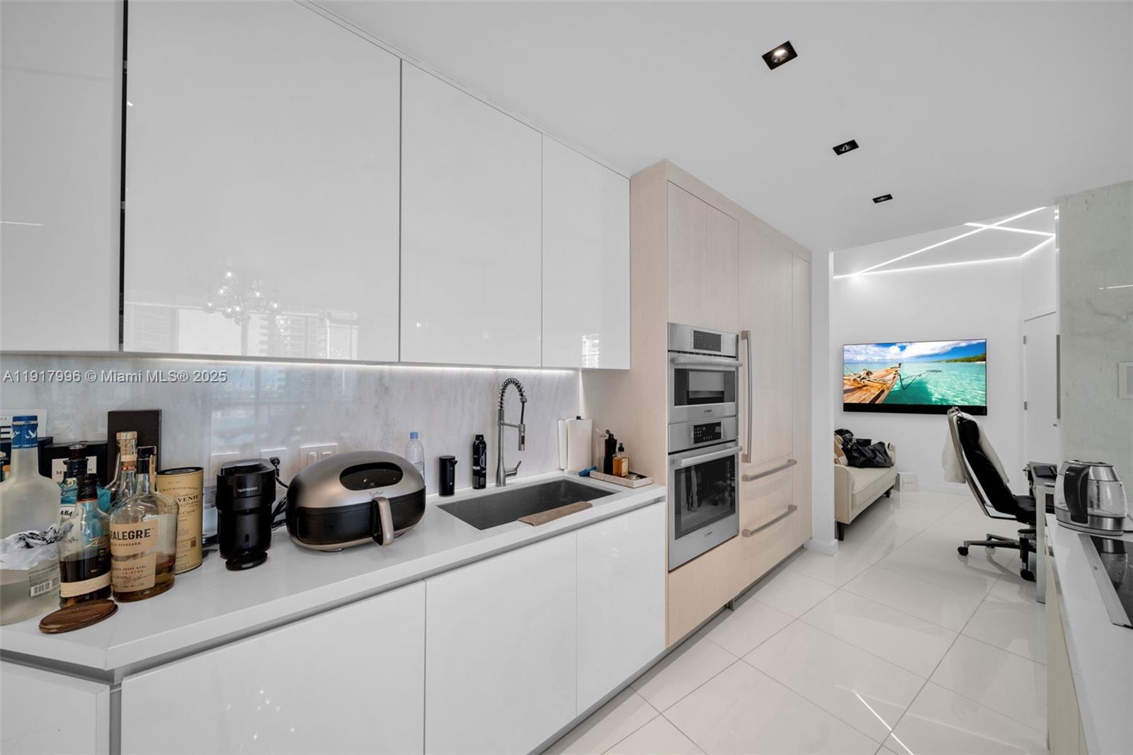 851 Northeast 1st Avenue, Unit 2203 Miami, FL 33132 - Photo 30 of 53 a kitchen with appliances cabinets and a counter top space