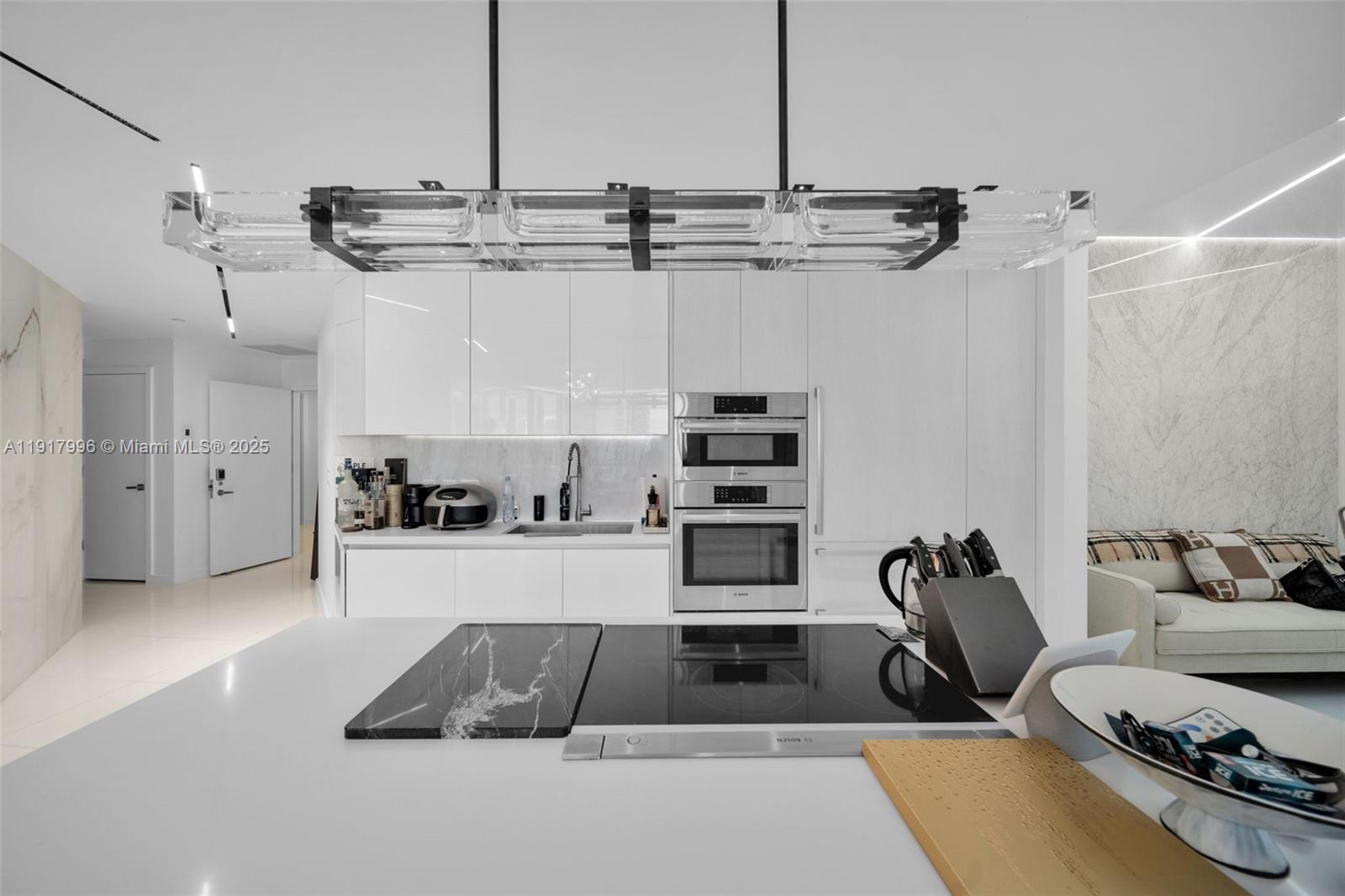 851 Northeast 1st Avenue, Unit 2203 Miami, FL 33132 - Photo 36 of 53 a kitchen with stainless steel appliances kitchen island granite countertop a sink and cabinets