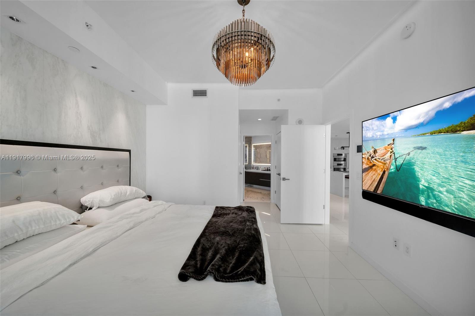 851 Northeast 1st Avenue, Unit 2203 Miami, FL 33132 - Photo 43 of 53 a bedroom with a bed and a large window