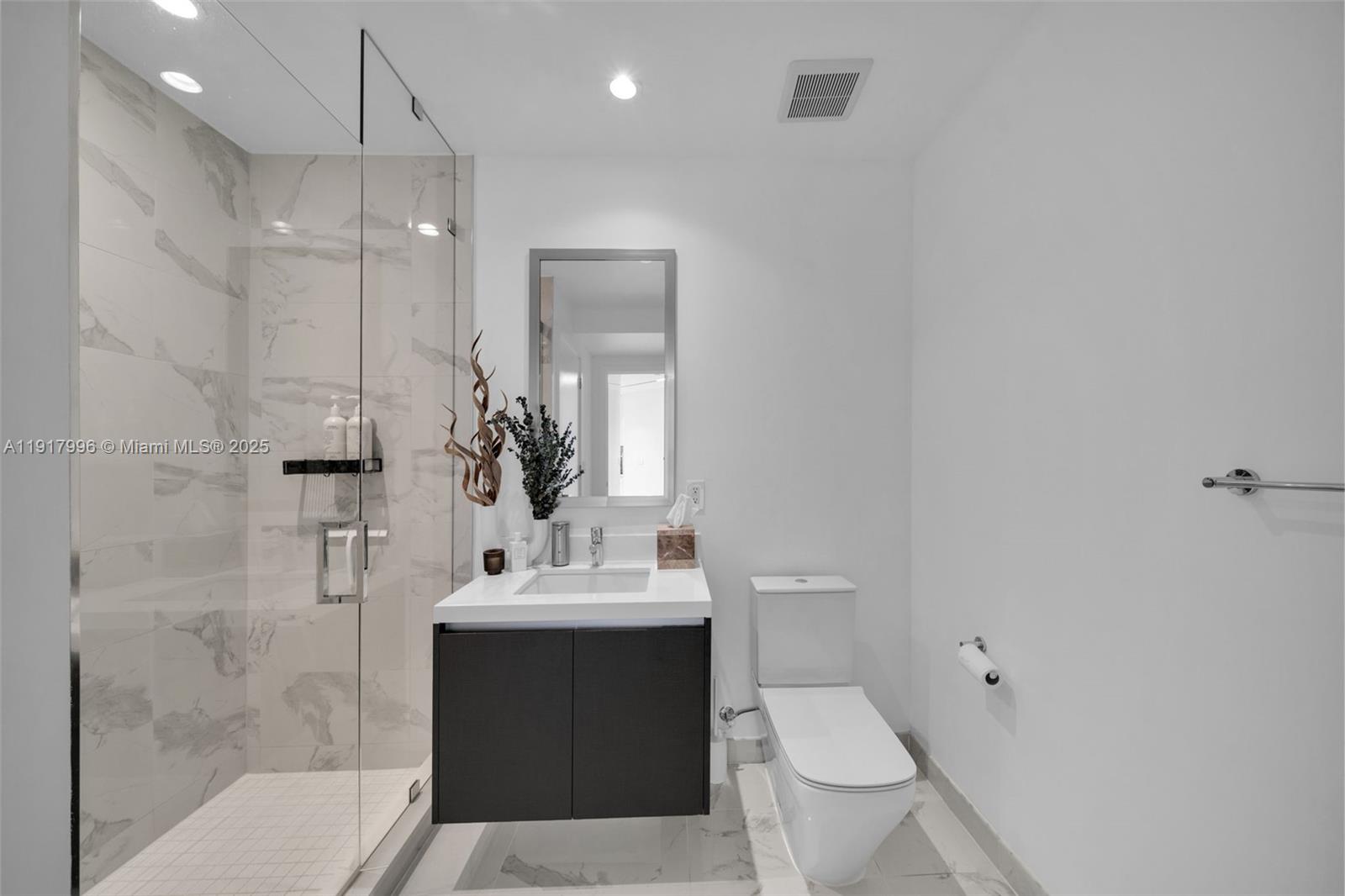 851 Northeast 1st Avenue, Unit 2203 Miami, FL 33132 - Photo 10 of 53 a bathroom with a sink toilet and shower