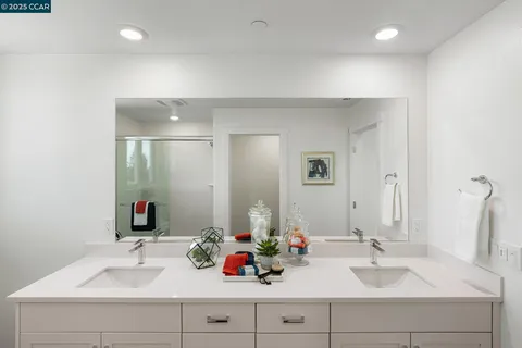 a bathroom with a sink double vanity and a mirror