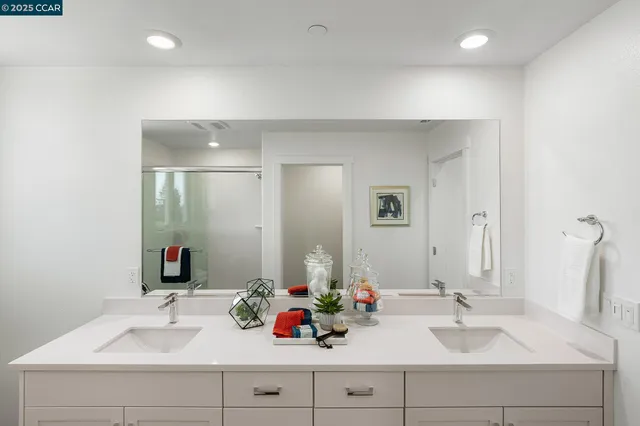 a bathroom with a sink double vanity and a mirror
