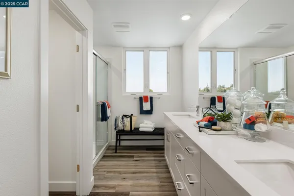 a kitchen with white cabinets and window
