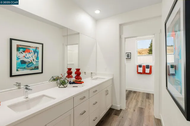 a bathroom with a double vanity sink mirror and double