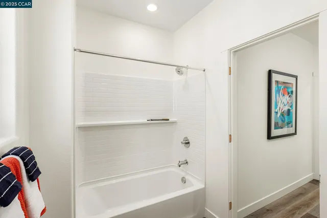 a bathroom with a shower and a bath tub