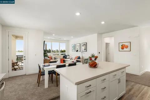 a kitchen view with dining table and chairs