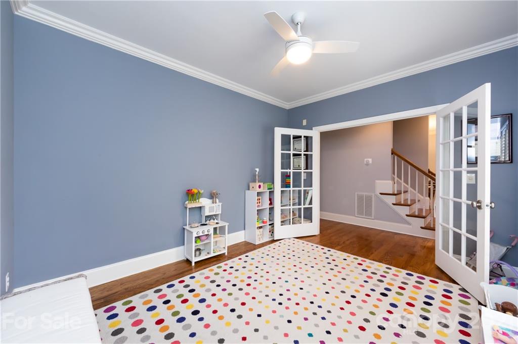 817 Millbrook Road Charlotte, NC 28211 - Photo 12 of 26 a bedroom with a bed and a chandelier