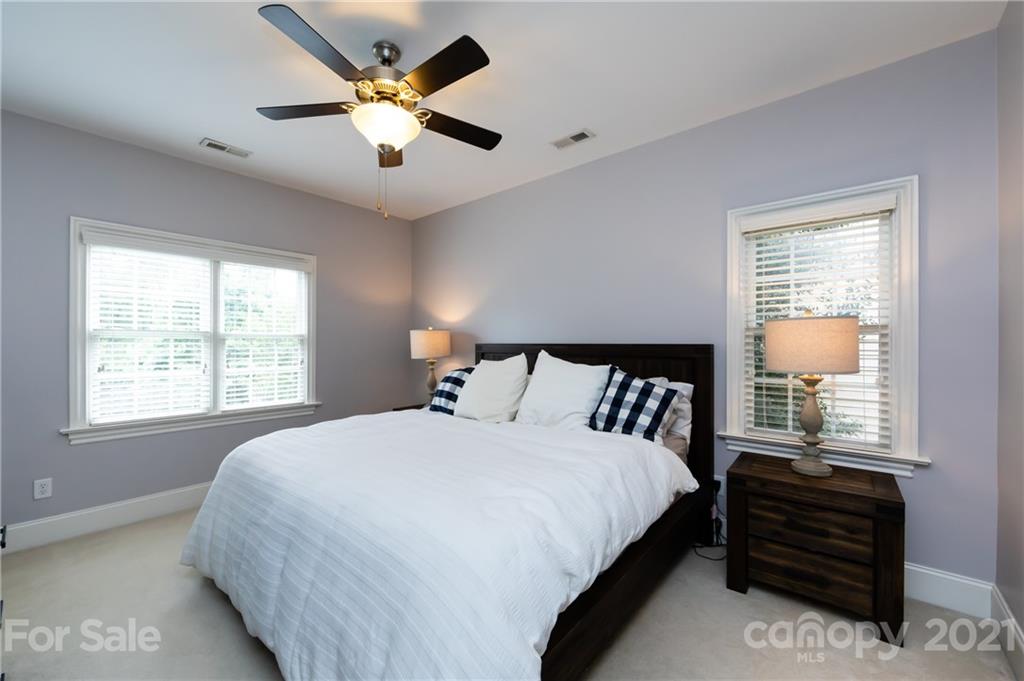 817 Millbrook Road Charlotte, NC 28211 - Photo 13 of 26 a bedroom with a large bed and a large window