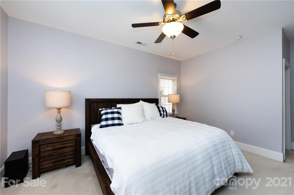 817 Millbrook Road Charlotte, NC 28211 - Photo 14 of 26 a bedroom with a bed and a lamp