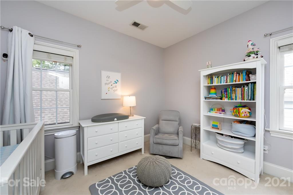 817 Millbrook Road Charlotte, NC 28211 - Photo 20 of 26 a room with furniture and a book shelf