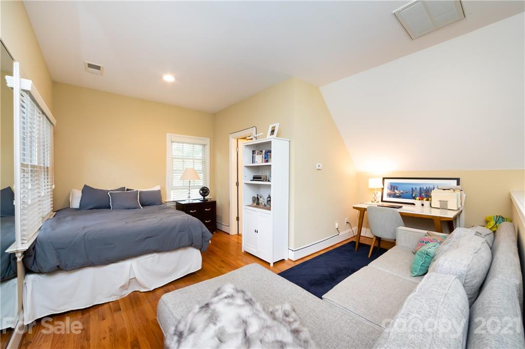 817 Millbrook Road Charlotte, NC 28211 - Photo 22 of 26 a bedroom with a bed and wooden floor