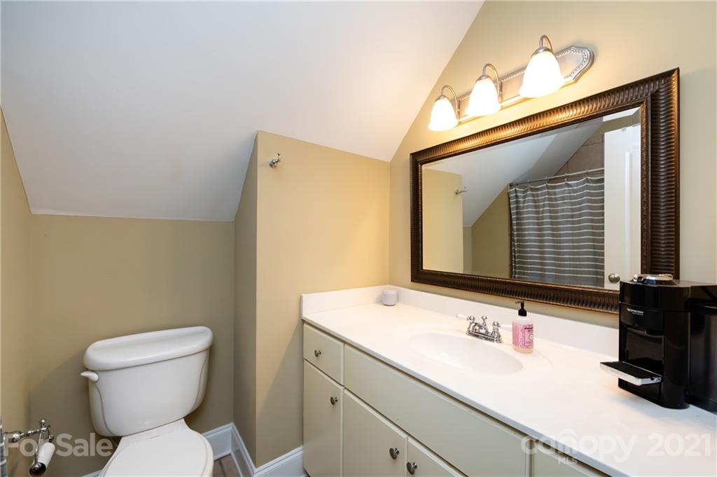 817 Millbrook Road Charlotte, NC 28211 - Photo 24 of 26 a bathroom with a toilet sink and mirror
