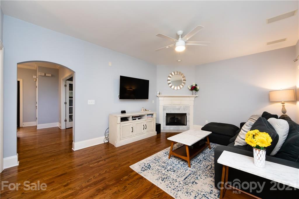 817 Millbrook Road Charlotte, NC 28211 - Photo 7 of 26 a living room with furniture and a flat screen tv with wooden floor