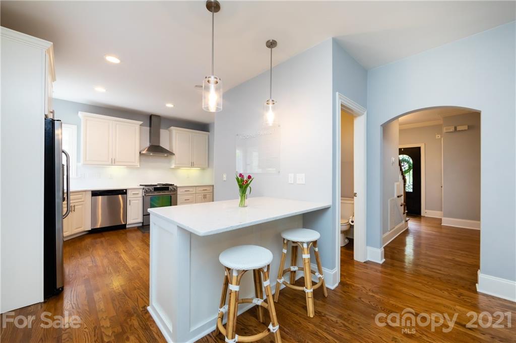 817 Millbrook Road Charlotte, NC 28211 - Photo 8 of 26 a kitchen with stainless steel appliances kitchen island granite countertop a table chairs and a refrigerator