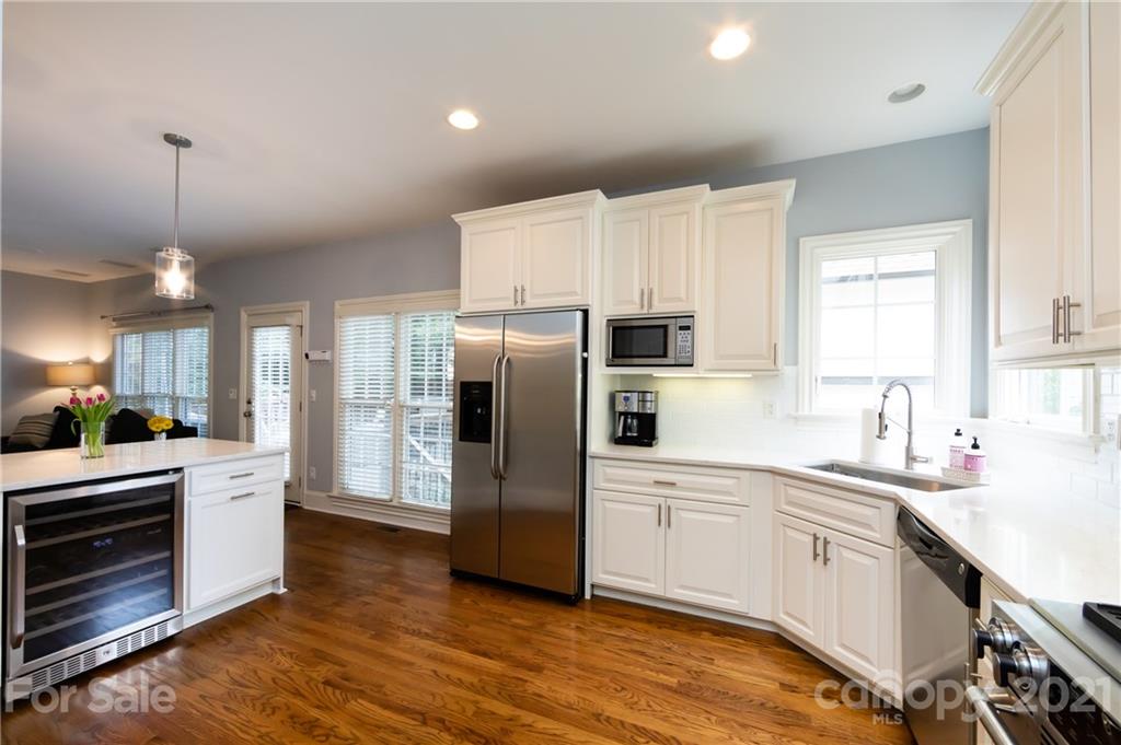 817 Millbrook Road Charlotte, NC 28211 - Photo 9 of 26 a kitchen with white cabinets and stainless steel appliances