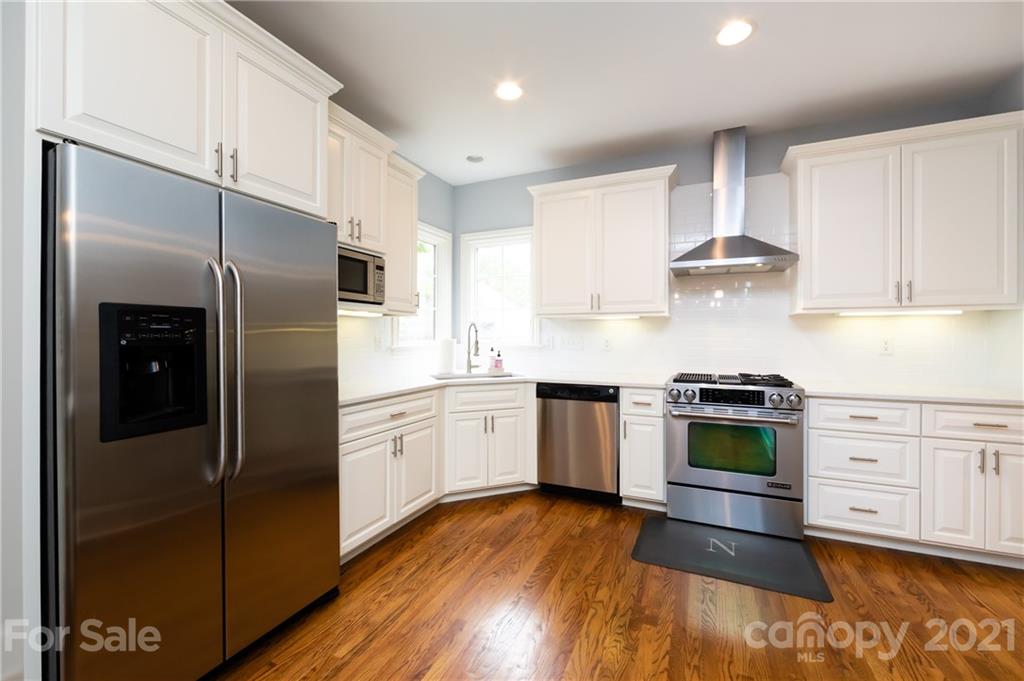 817 Millbrook Road Charlotte, NC 28211 - Photo 10 of 26 a kitchen with a refrigerator stove and wooden cabinets