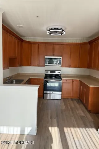 a kitchen with wooden cabinets and stainless steel appliances