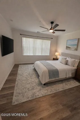 a bedroom with a large bed and a flat screen tv