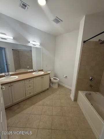 a bathroom with a sink a toilet and mirror