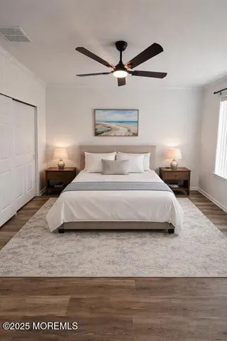 a bedroom with a bed and wooden floor