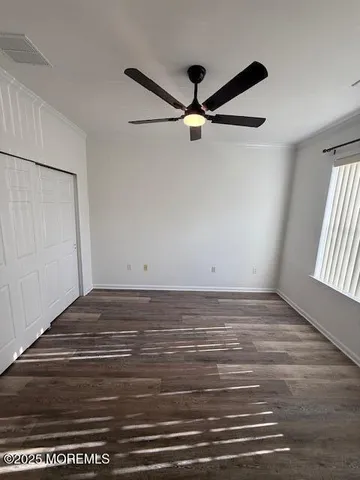 a view of room with hardwood floor and window