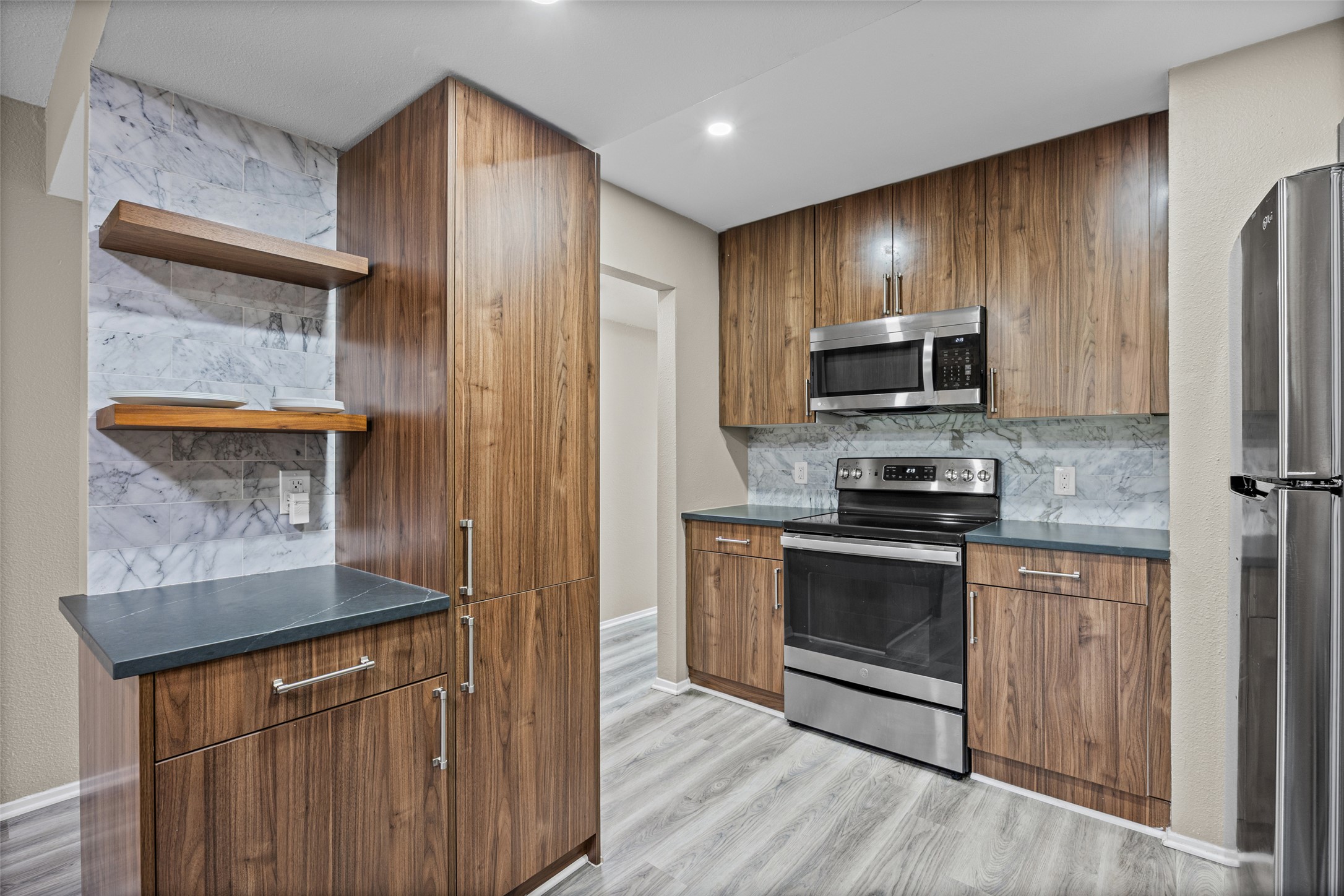 3809 Menchaca Road, Unit C Austin, TX 78704 - Photo 4 of 28 Modern kitchen with custom cabinetry and sleek stainless steel appliances.