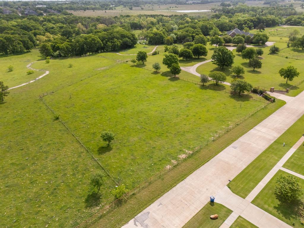 Tbd Sleepy Hollow Road Ennis, TX 75119 - Photo 2 of 11 Expansive green fields with scattered trees and a paved road