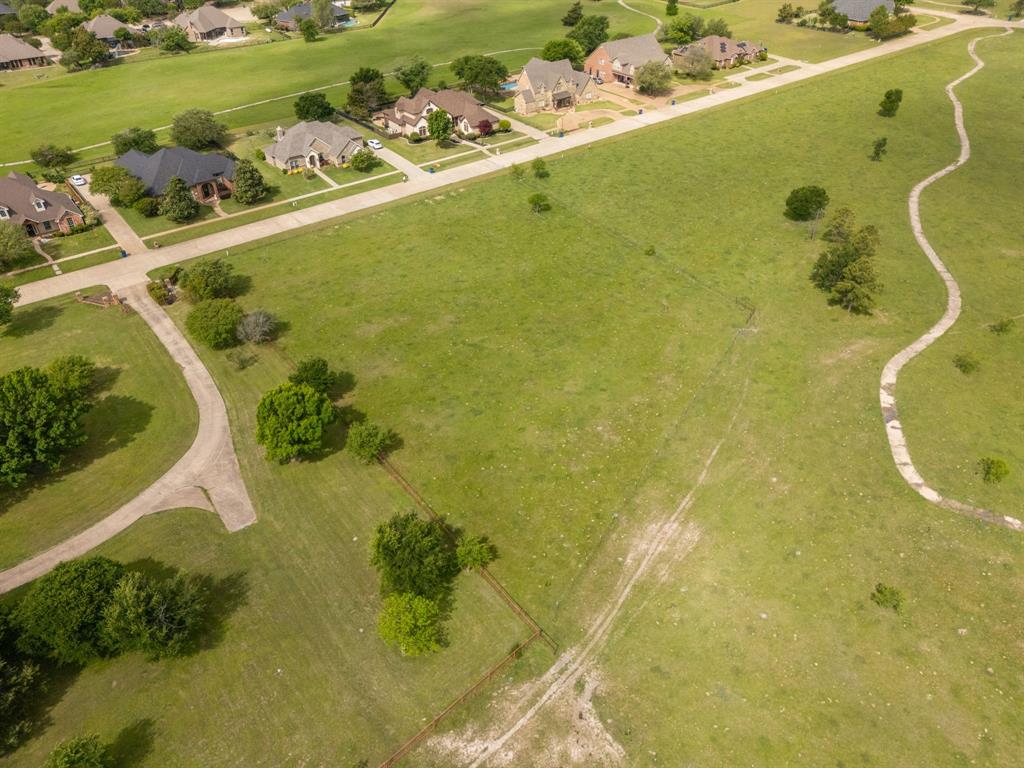 Tbd Sleepy Hollow Road Ennis, TX 75119 - Photo 9 of 11 Expansive green landscape featuring scattered trees and a winding paved path