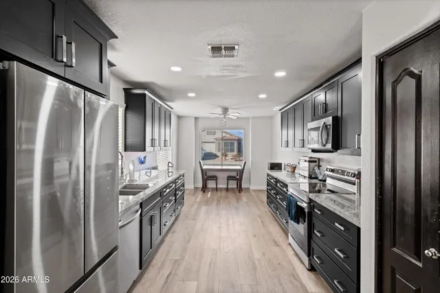a kitchen with stainless steel appliances a refrigerator stove and sink