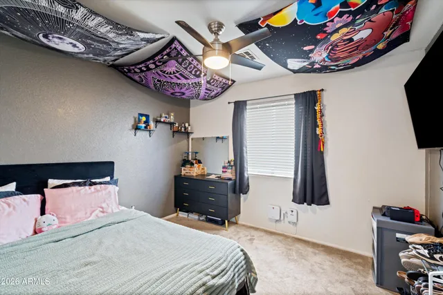 a bedroom with a bed and a tv