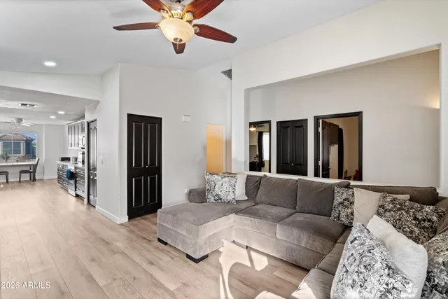 a bedroom with furniture and a large window