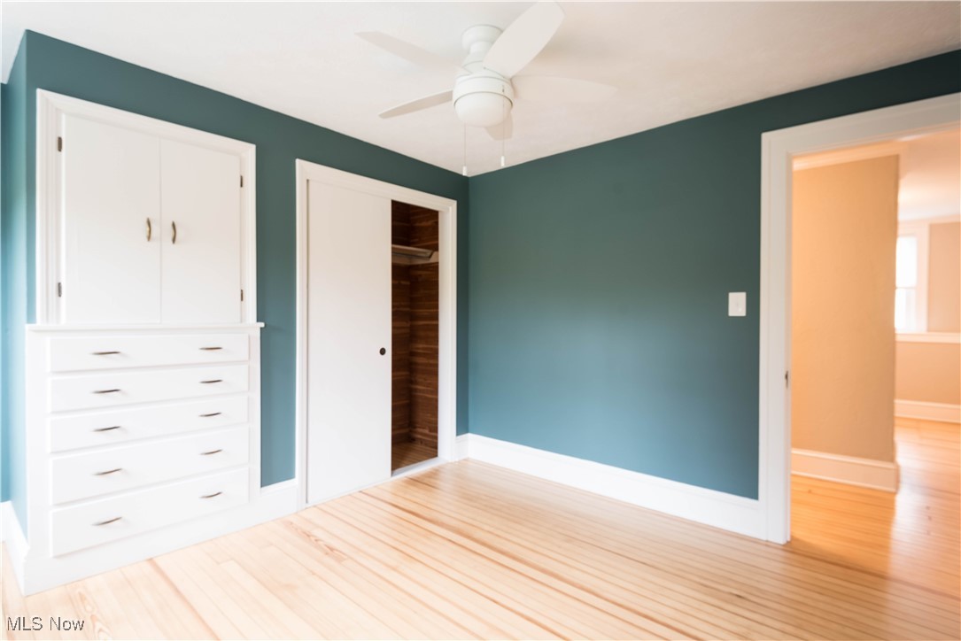 7003 Brecksville Road Independence, OH 44131 - Photo 12 of 35 Unfurnished bedroom featuring light wood-style floors, a closet, and ceiling fan