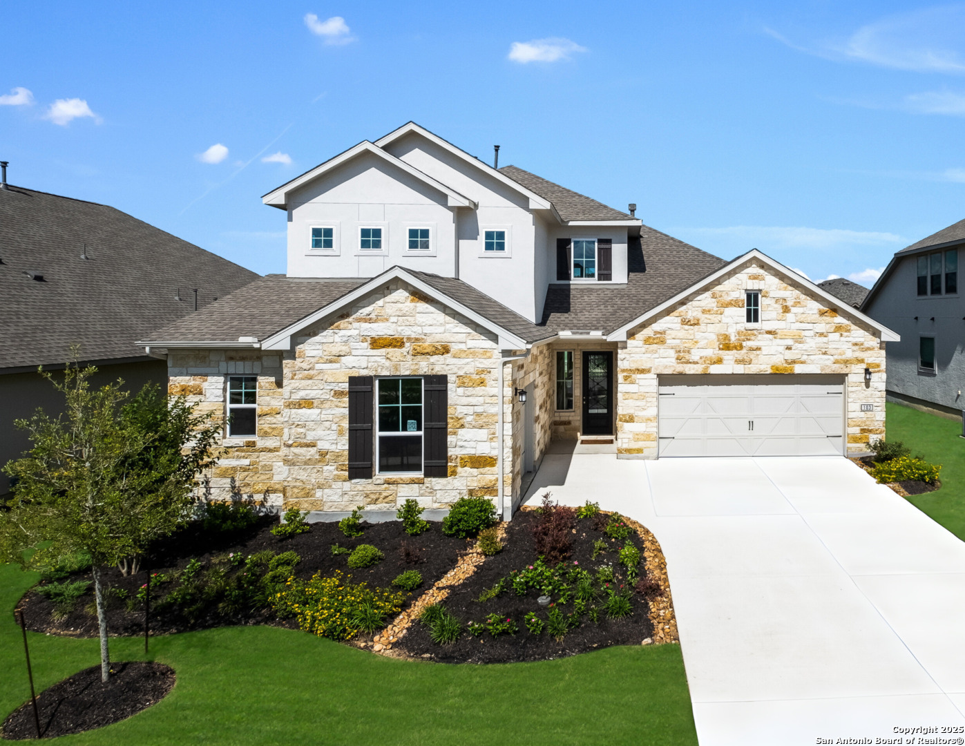 a front view of a house with a yard and garage