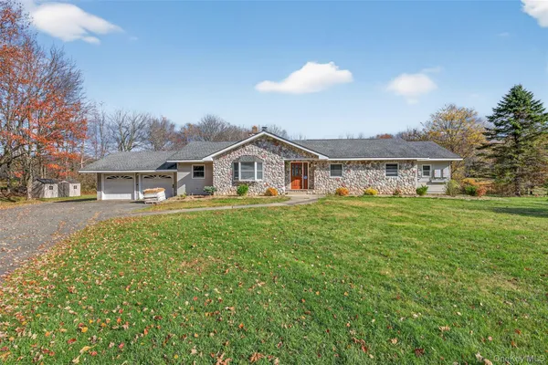 a view of house with yard and entertaining space