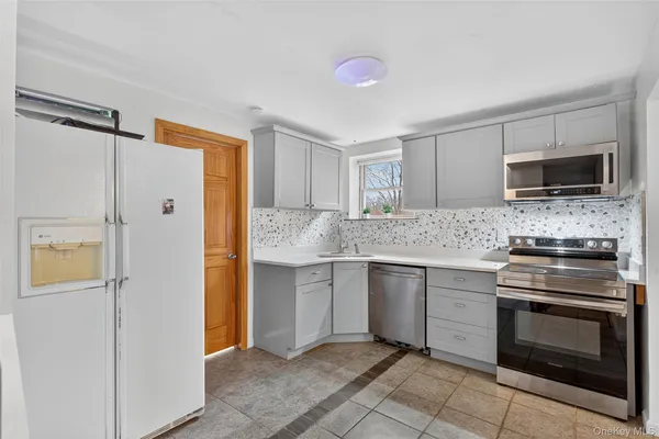 a kitchen with a sink stove and refrigerator